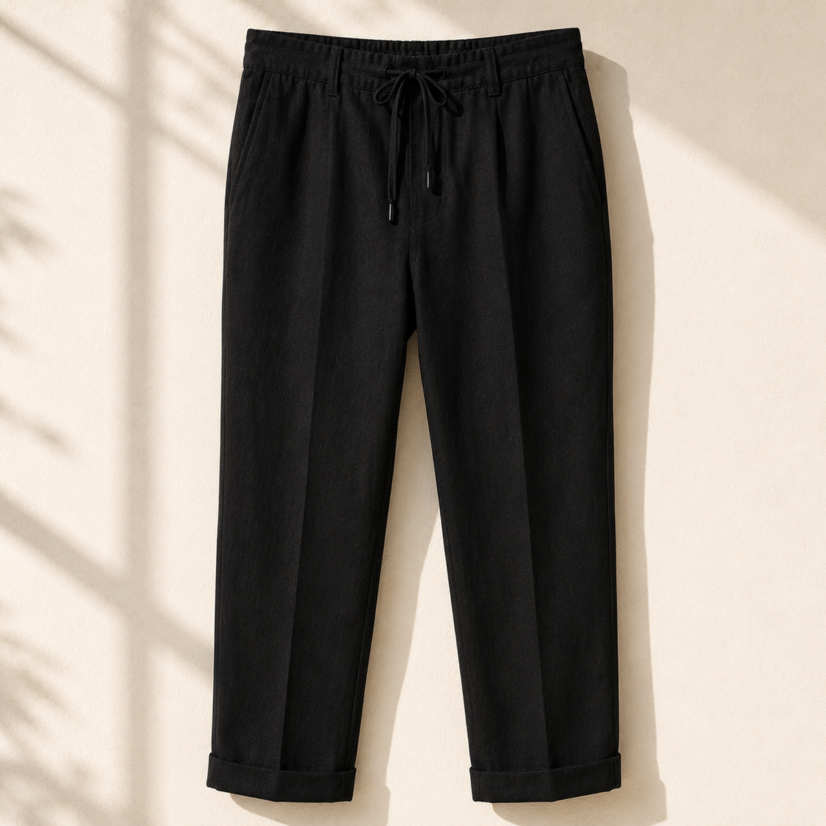 Men's black linen drawstring pants relaxed fit on neutral background - Rivaro