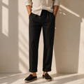 Model wearing men's black linen drawstring trousers with rolled cuffs and espadrilles - Rivaro