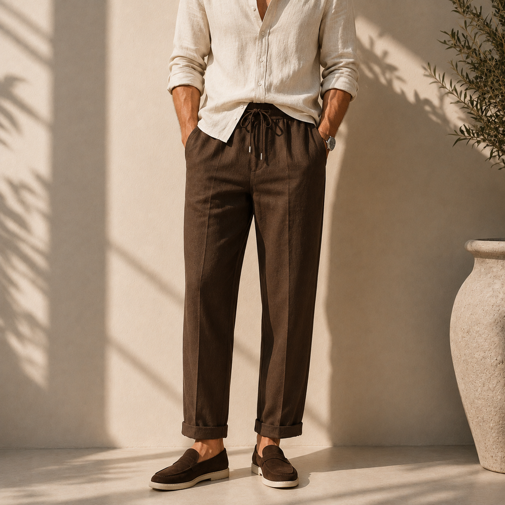 Model wearing men's brown linen drawstring trousers with natural beige shirt - Rivaro