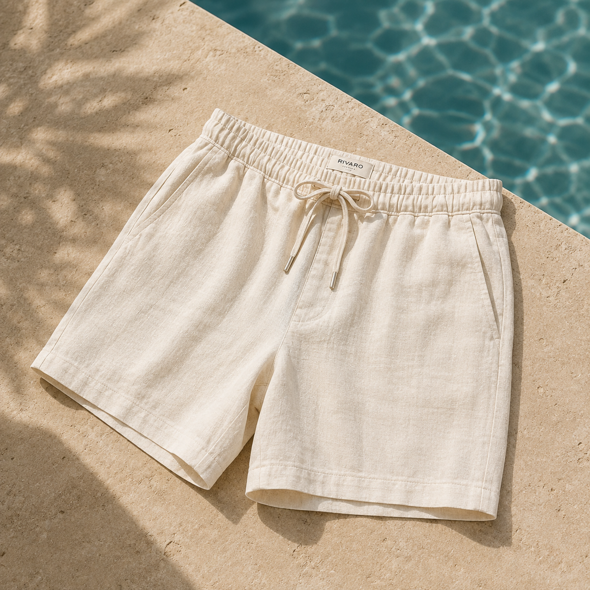 Men's beige linen drawstring shorts by the pool - Rivaro Shorts Collection