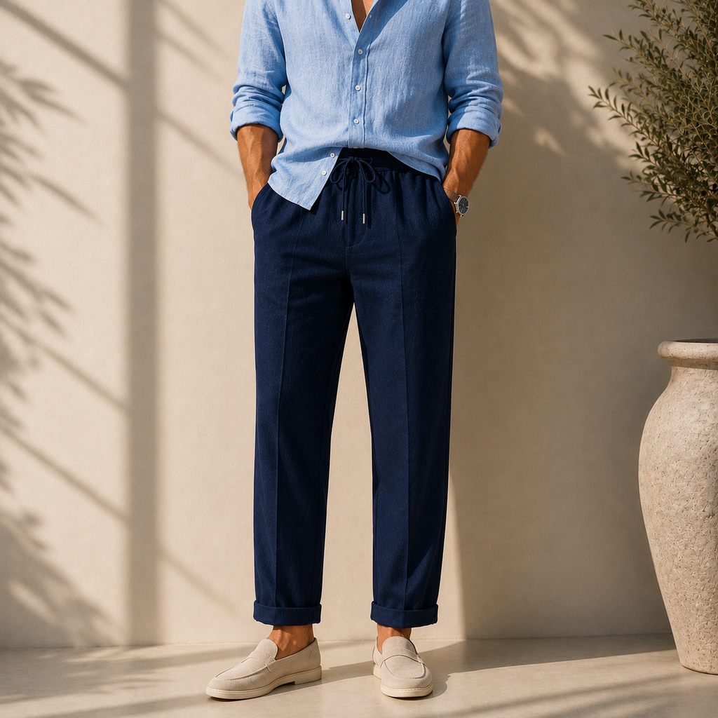 Model wearing men's navy blue linen drawstring trousers paired with sky blue shirt - Rivaro