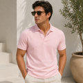 Model wearing men's pastel pink linen polo shirt in sunlit Mediterranean terrace - Rivaro
