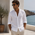 Model wearing men's classic white linen shirt against sunlit stone wall - Rivaro